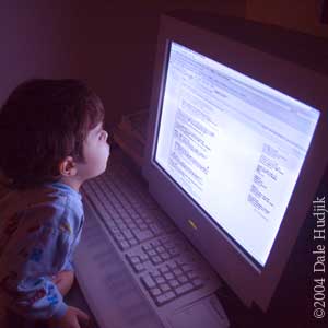 4 year old boy looking at a computer screen