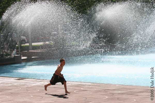 Boy Running by City Hall Pool