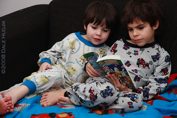 two little boys reading a comic book