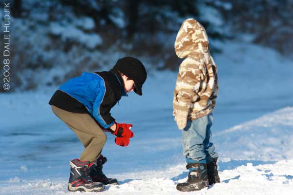 two little boys playing in the snow